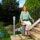 Happy woman sat on an outdoor stairlift for straight stairs.