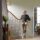 A man is going up the stairs with a Stannah stairlift for curved stairs