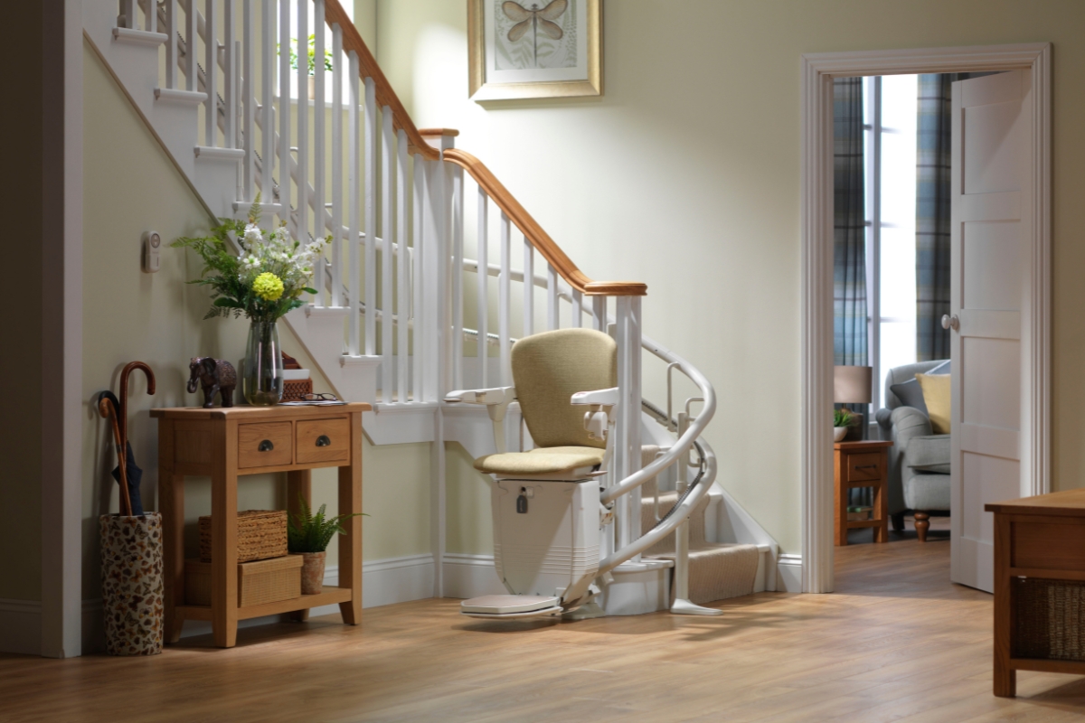 Stannah stairlift for curved stairs stopped at the bottom.
