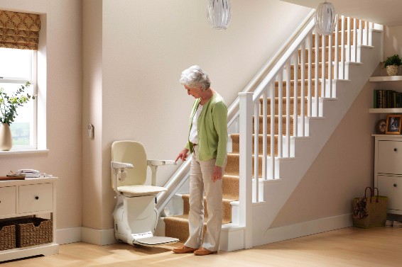 Woman looking at her Stannah stairlift for straight stairs.