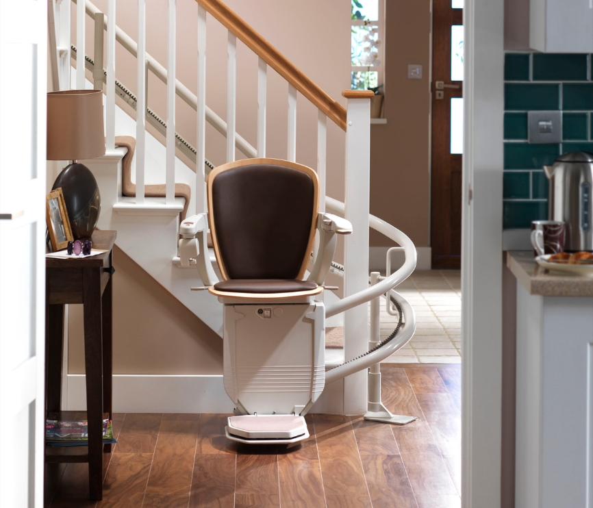 Stannah Starla stairlift for curved stairs with brown leather upholstery.
